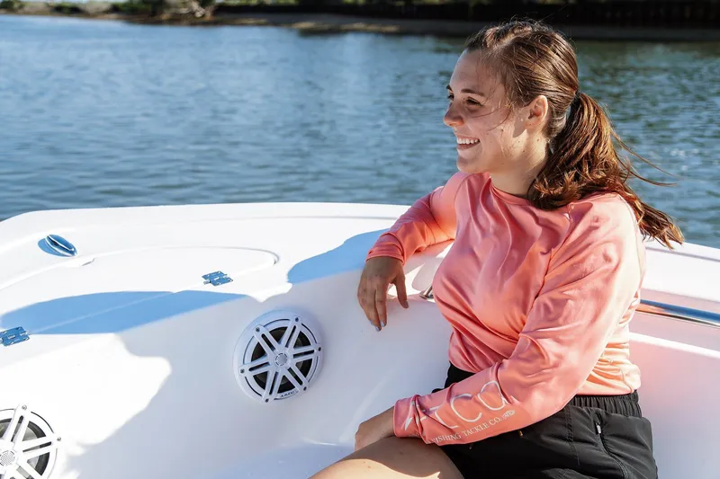 Slide: The Image of Smiling woman on 2026 Tidewater 198 CC Adventure boat, enjoying a sunny day on the water. - 9