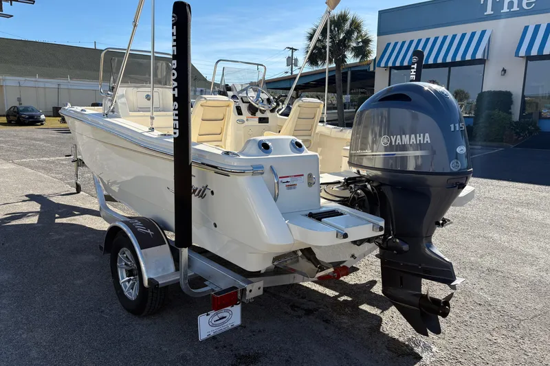 Slide: The Image of 2026 Scout 188 Sport Dorado boat with Yamaha 115 engine, parked outdoors. - 2