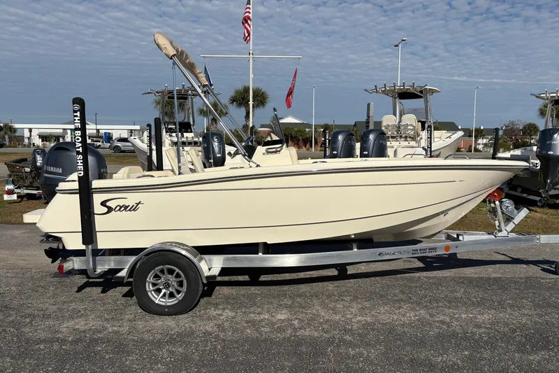 Slide: The Image of 2026 Scout 188 Sport Dorado boat on trailer, parked outdoors under clear sky. - 5
