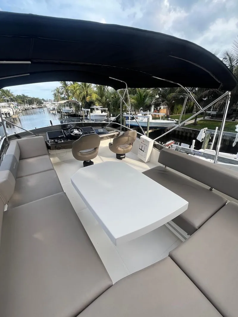 Slide: The Image of 2017 Marquis 500 Sport Yacht with spacious seating and table on deck. - 12