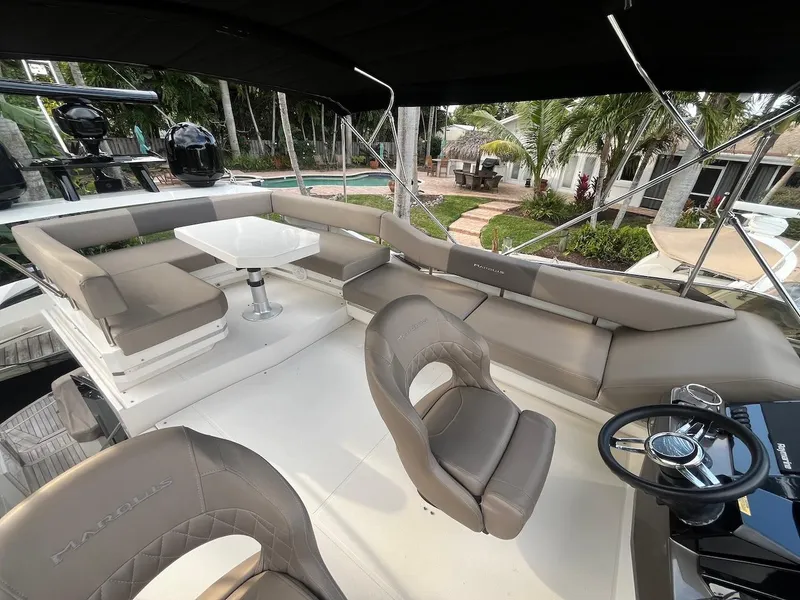 Slide: The Image of 2017 Marquis 500 Sport Yacht interior with seating and steering area. - 14