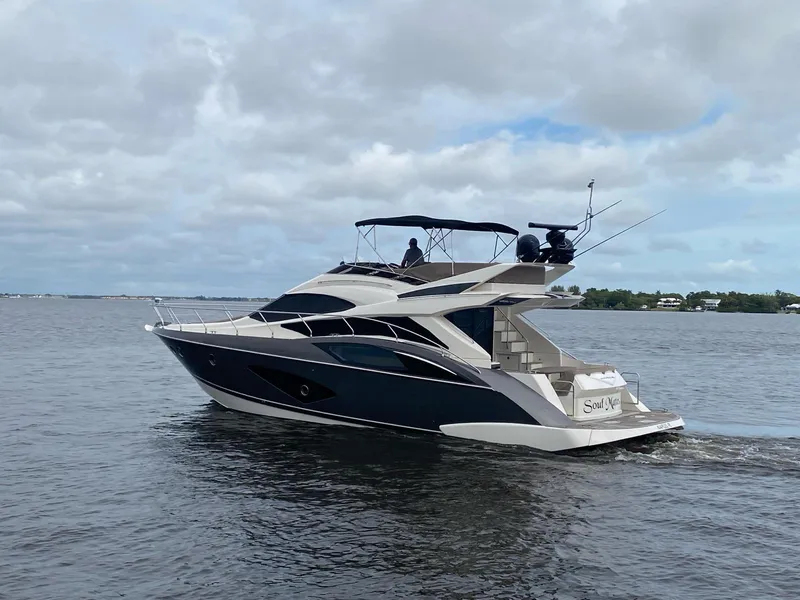 Slide: The Image of 2017 Marquis 500 Sport Yacht cruising on a calm, cloudy day. - 2