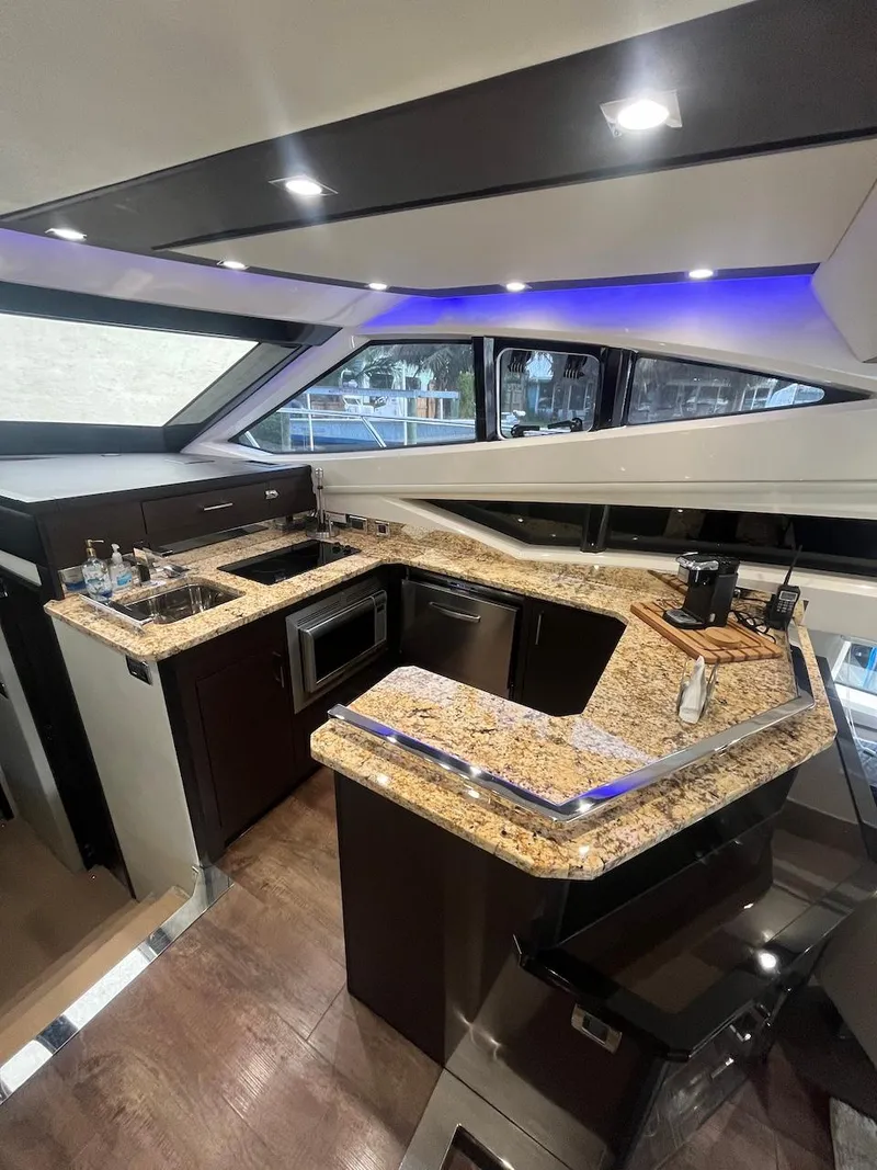 Slide: The Image of Luxurious kitchen area in a 2017 Marquis 500 Sport Yacht with granite countertops. - 26