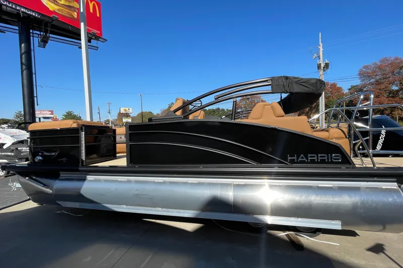 The Image of 2026 Harris Cruiser 210 pontoon boat with sleek black design and tan seating. - 1