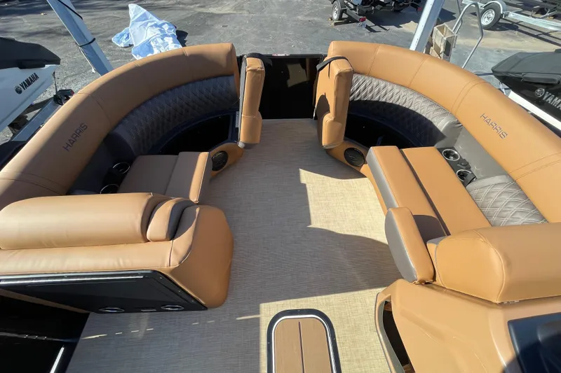 Slide: The Image of 2026 Harris Cruiser 210 boat interior with tan leather seating and cup holders. - 11