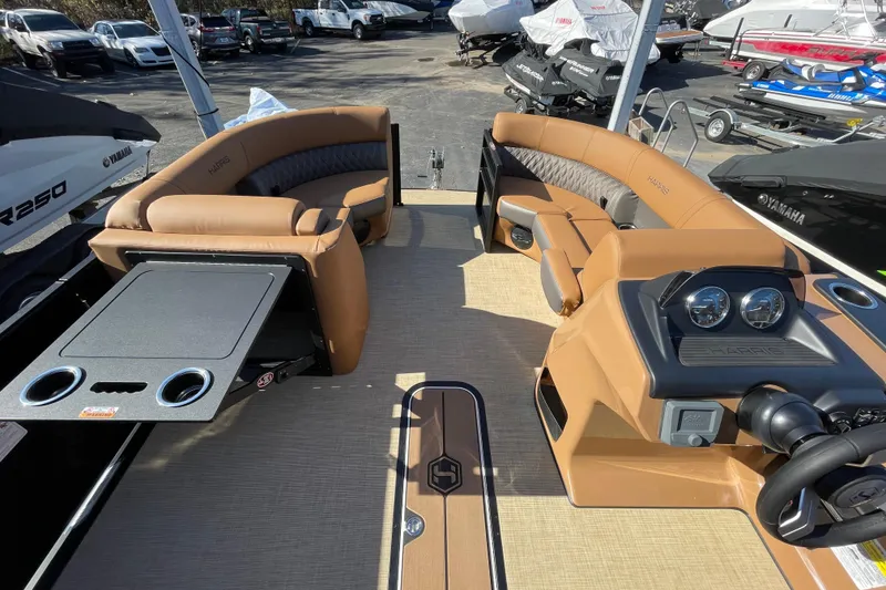 Slide: The Image of 2026 Harris Cruiser 210 boat interior with tan seating and modern dashboard. - 12