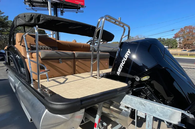 Slide: The Image of 2026 Harris Cruiser 210 pontoon boat with Mercury engine, featuring tan seating and sleek design. - 16