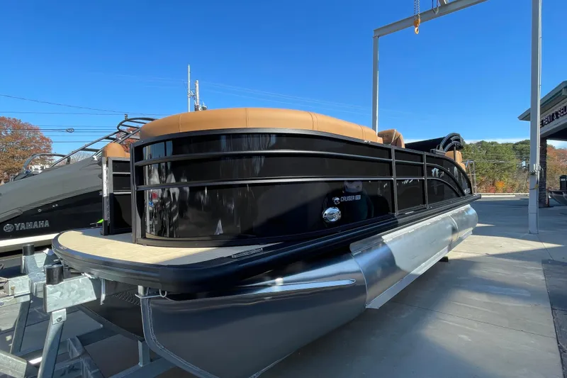 Slide: The Image of 2026 Harris Cruiser 210 pontoon boat displayed outdoors on a sunny day. - 19