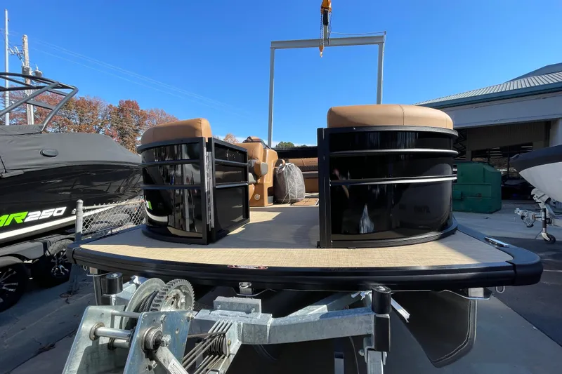 Slide: The Image of 2026 Harris Cruiser 210 pontoon boat on trailer under clear blue sky. - 20