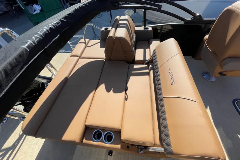 Slide: The Image of 2026 Harris Cruiser 210 boat interior with tan leather seating and cup holders. - 5
