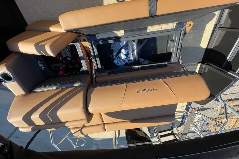 Slide: The Image of 2026 Harris Cruiser 210 boat interior with tan seating and modern design. - 6