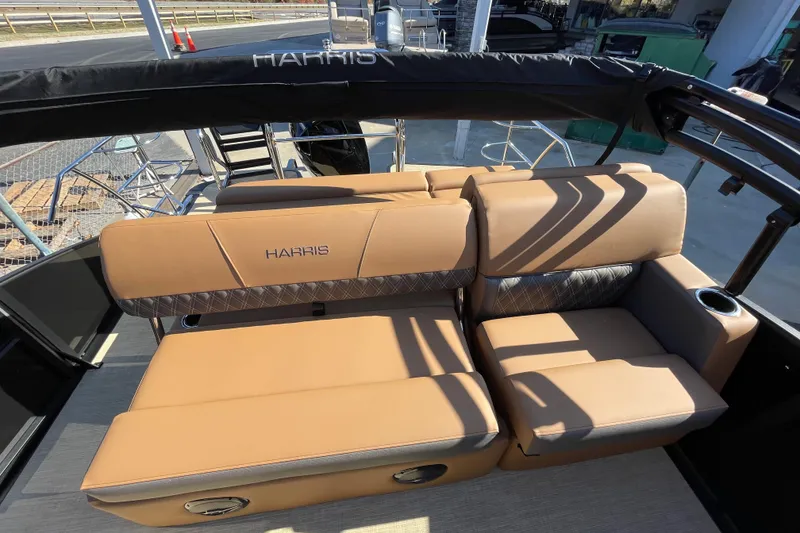 Slide: The Image of 2026 Harris Cruiser 210 boat interior with tan seating and cup holders. - 8