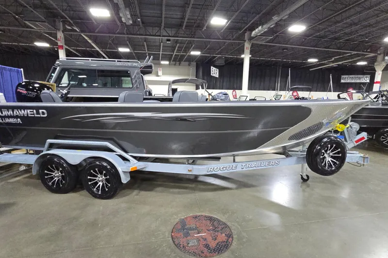 The Image of 2026 Alumaweld Columbia 21 boat on Rogue trailer at indoor exhibition. - 0