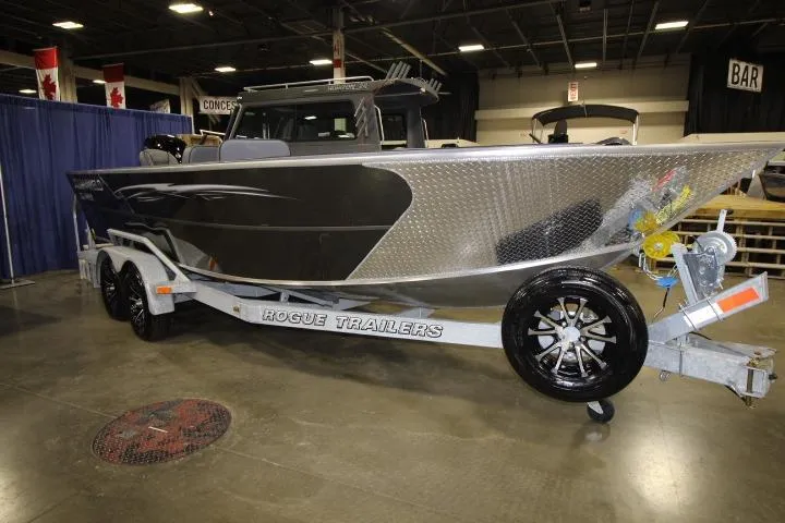 Slide: The Image of 2026 Alumaweld Columbia 21 boat on Rogue trailer at indoor exhibition. - 1