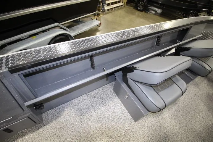 Slide: The Image of 2026 Alumaweld Columbia 21 boat interior with gray seating and diamond plate accents. - 12