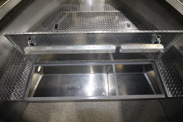 Slide: The Image of Open storage compartment in 2026 Alumaweld Columbia 21 boat with diamond plate flooring. - 15