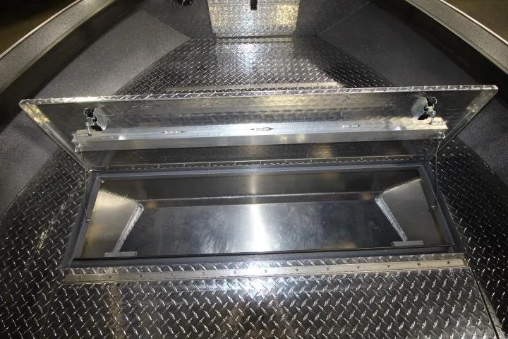 Slide: The Image of Open storage compartment in 2026 Alumaweld Columbia 21 boat with diamond plate flooring. - 6