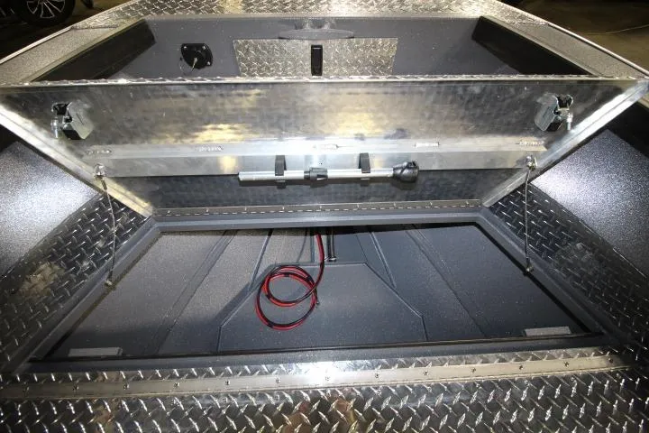 Slide: The Image of Open storage compartment of 2026 Alumaweld Columbia 21 boat with diamond plate detailing. - 7