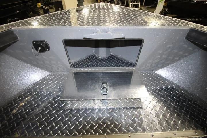 Slide: The Image of 2026 Alumaweld Columbia 21 boat interior with diamond plate flooring and storage compartment. - 8