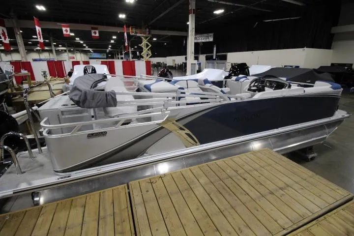 Slide: The Image of 2026 Avalon LSZ Rear Fish pontoon boat displayed indoors at a boat show. - 1
