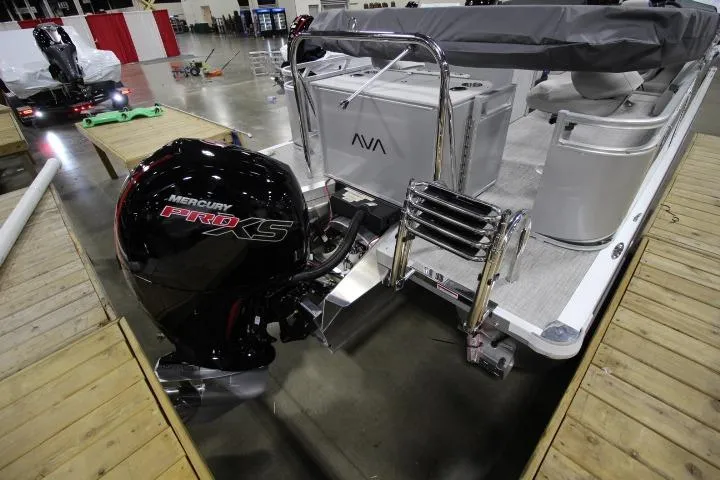 Slide: The Image of 2026 Avalon LSZ Rear Fish boat with Mercury Pro XS engine displayed indoors. - 3