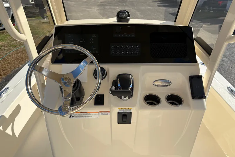 Slide: The Image of 2026 Scout 231 XSB boat dashboard with steering wheel and control panel. - 15