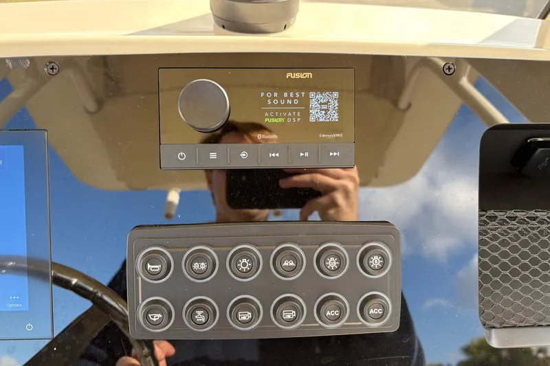 Slide: The Image of 2026 Scout 231 XSB boat dashboard with Fusion audio system and control panel. - 18