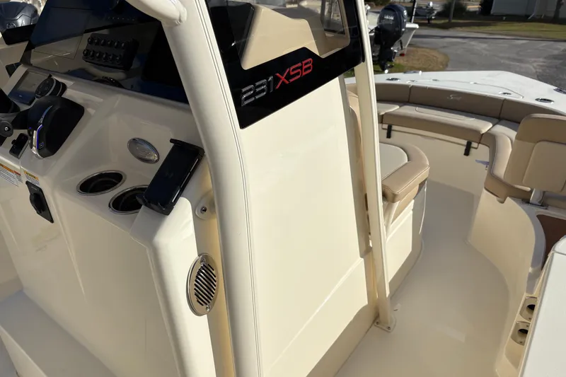 Slide: The Image of 2026 Scout 231 XSB boat interior with helm, seating, and control panel. - 19