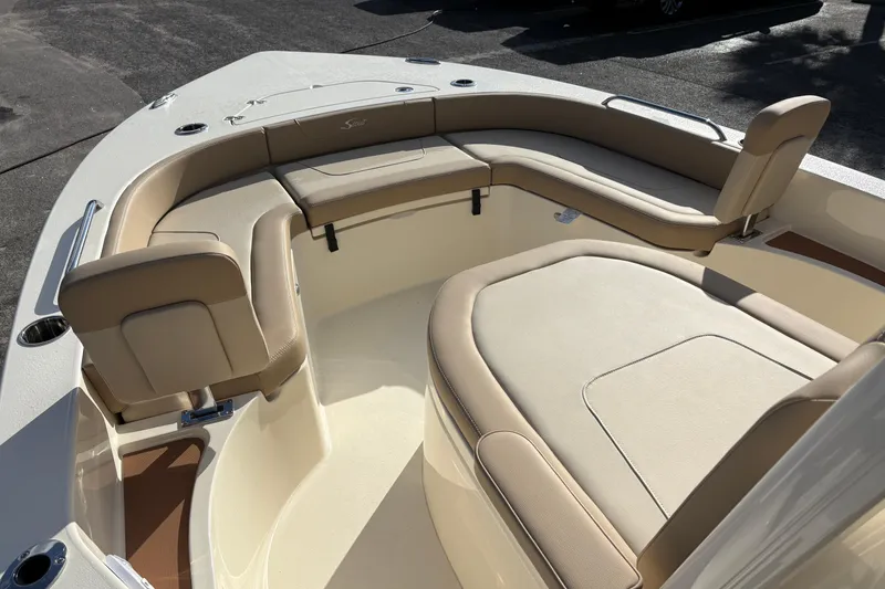 Slide: The Image of 2026 Scout 231 XSB boat interior with beige seating and spacious layout. - 22