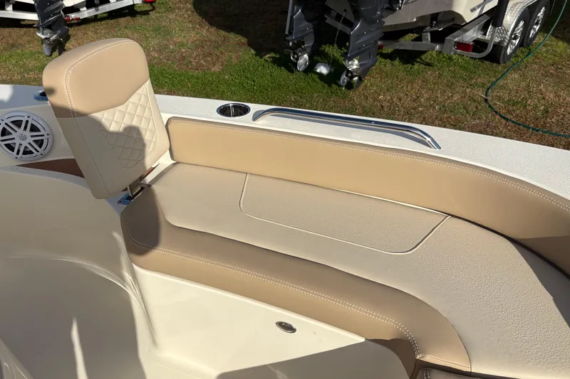 Slide: The Image of 2026 Scout 231 XSB boat interior with beige seating and speaker detail. - 27