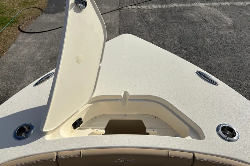 Slide: The Image of Open storage compartment on 2026 Scout 231 XSB boat deck. - 28