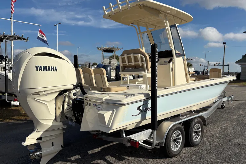 Slide: The Image of 2026 Scout 231 XSB boat with Yamaha engine on trailer, outdoor display. - 4