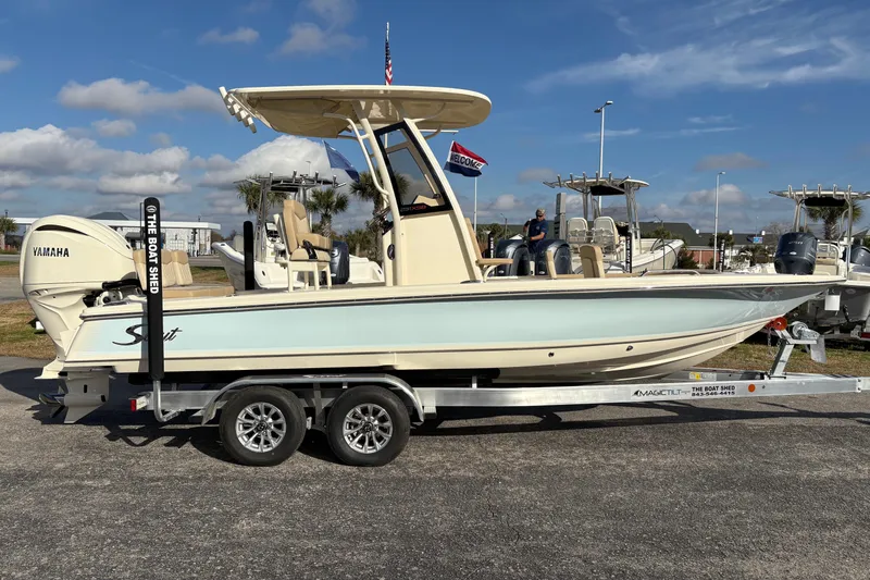Slide: The Image of 2026 Scout 231 XSB boat on trailer with Yamaha engine, displayed outdoors. - 5