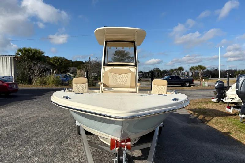 Slide: The Image of 2026 Scout 231 XSB boat on trailer, parked outdoors under a clear blue sky. - 7