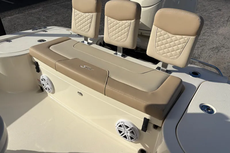 Slide: The Image of 2026 Scout 231 XSB boat seating with beige cushions and integrated speakers. - 9