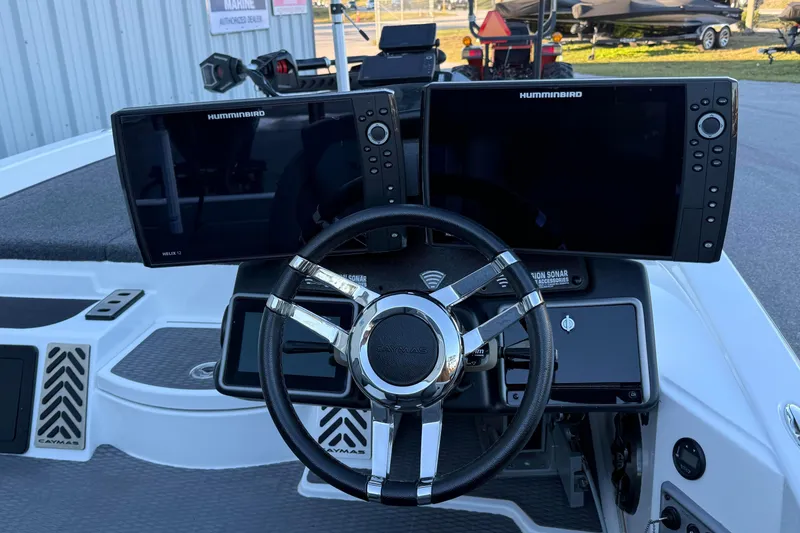 Slide: The Image of 2022 Caymas CX 20 PRO boat dashboard with dual Humminbird displays and steering wheel. - 3