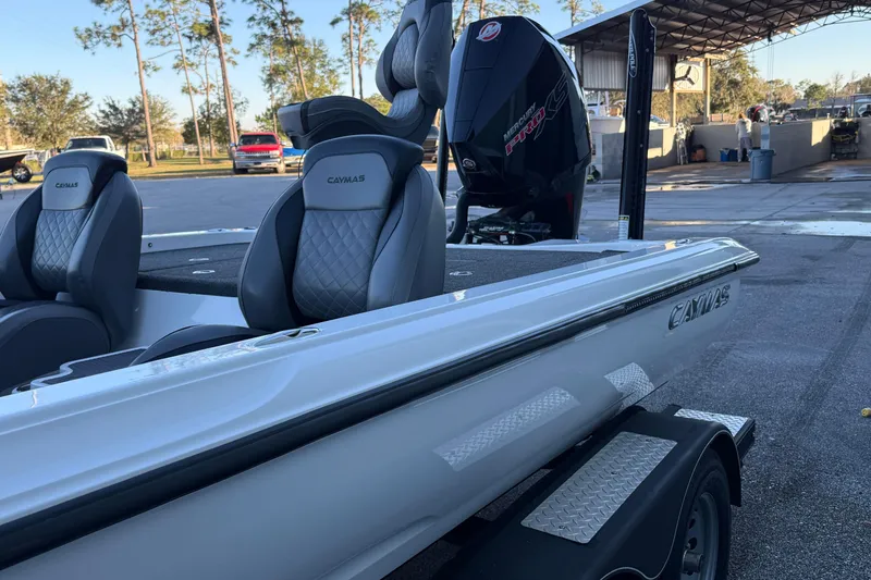 Slide: The Image of 2022 Caymas CX 20 PRO boat with Mercury engine, parked outdoors. - 8