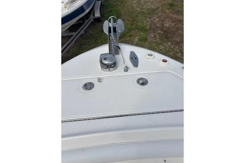 Slide: The Image of 2013 Wellcraft 30 Scarab Sport boat with Evinrude engines and cushioned seating. - 11