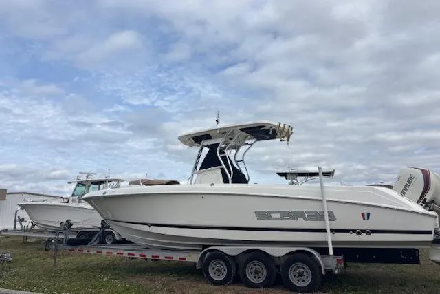 Slide: The Image of 2013 Wellcraft 30 Scarab Sport boat on trailer under cloudy sky. - 2