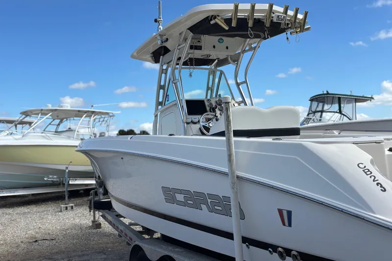 Slide: The Image of 2013 Wellcraft 30 Scarab Sport boat on trailer under blue sky. - 3