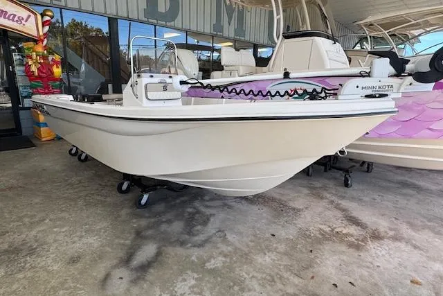 Slide: The Image of 2023 Carolina Skiff 162 JLS boat displayed in showroom, featuring a sleek design and modern equipment. - 10