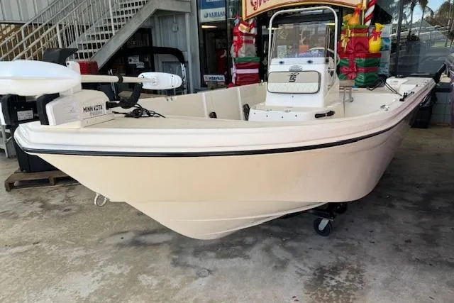 Slide: The Image of 2023 Carolina Skiff 162 JLS boat displayed indoors, featuring a sleek design. - 12