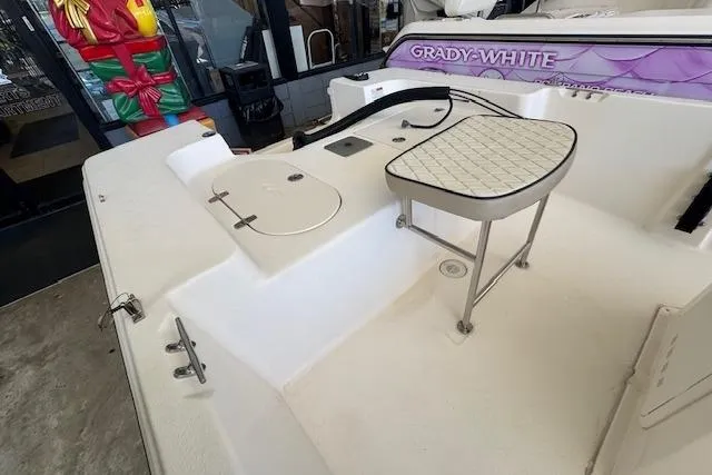 Slide: The Image of 2023 Carolina Skiff 162 JLS boat interior with seating and storage compartments. - 5