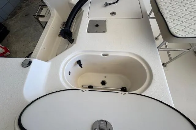 Slide: The Image of 2023 Carolina Skiff 162 JLS boat interior with storage compartments and seating. - 6