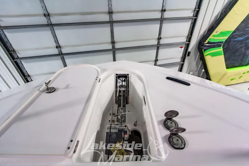 Slide: The Image of 2026 Tidewater 256 LXF boat anchor compartment in a marina garage. - 102