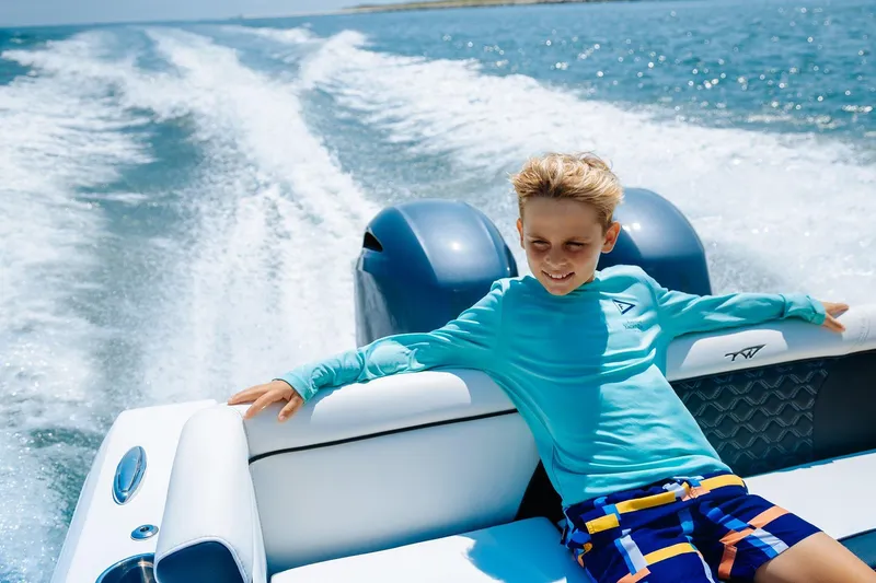 Slide: The Image of 2026 Tidewater 256 LXF boat on trailer at marina, under blue sky. - 14