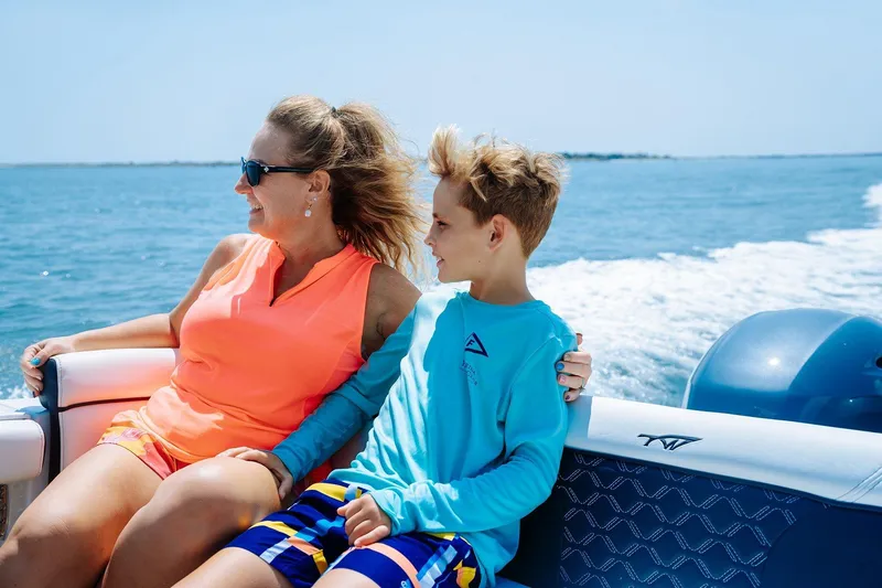 Slide: The Image of 2026 Tidewater 256 LXF boat on trailer at Lakeside Marina under blue sky. - 15