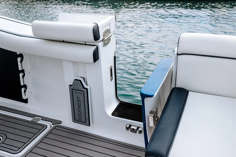 Slide: The Image of 2026 Tidewater 256 LXF boat on trailer at Lakeside Marina, under clear blue sky. - 16