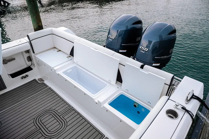 Slide: The Image of 2026 Tidewater 256 LXF boat with dual engines on a trailer at Lakeside Marina. - 19