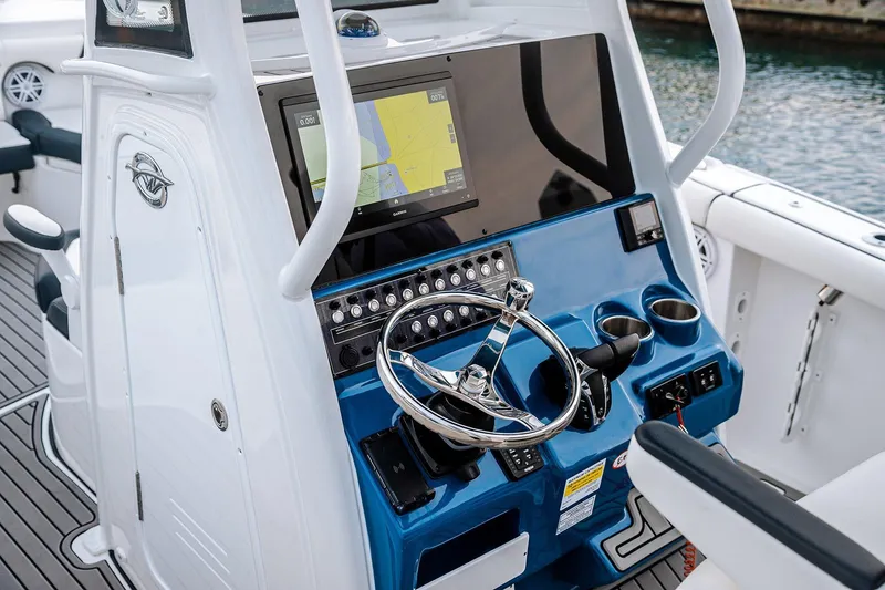 Slide: The Image of 2026 Tidewater 256 LXF boat on trailer, featuring powerful outboard engine, at Lakeside Marina. - 20